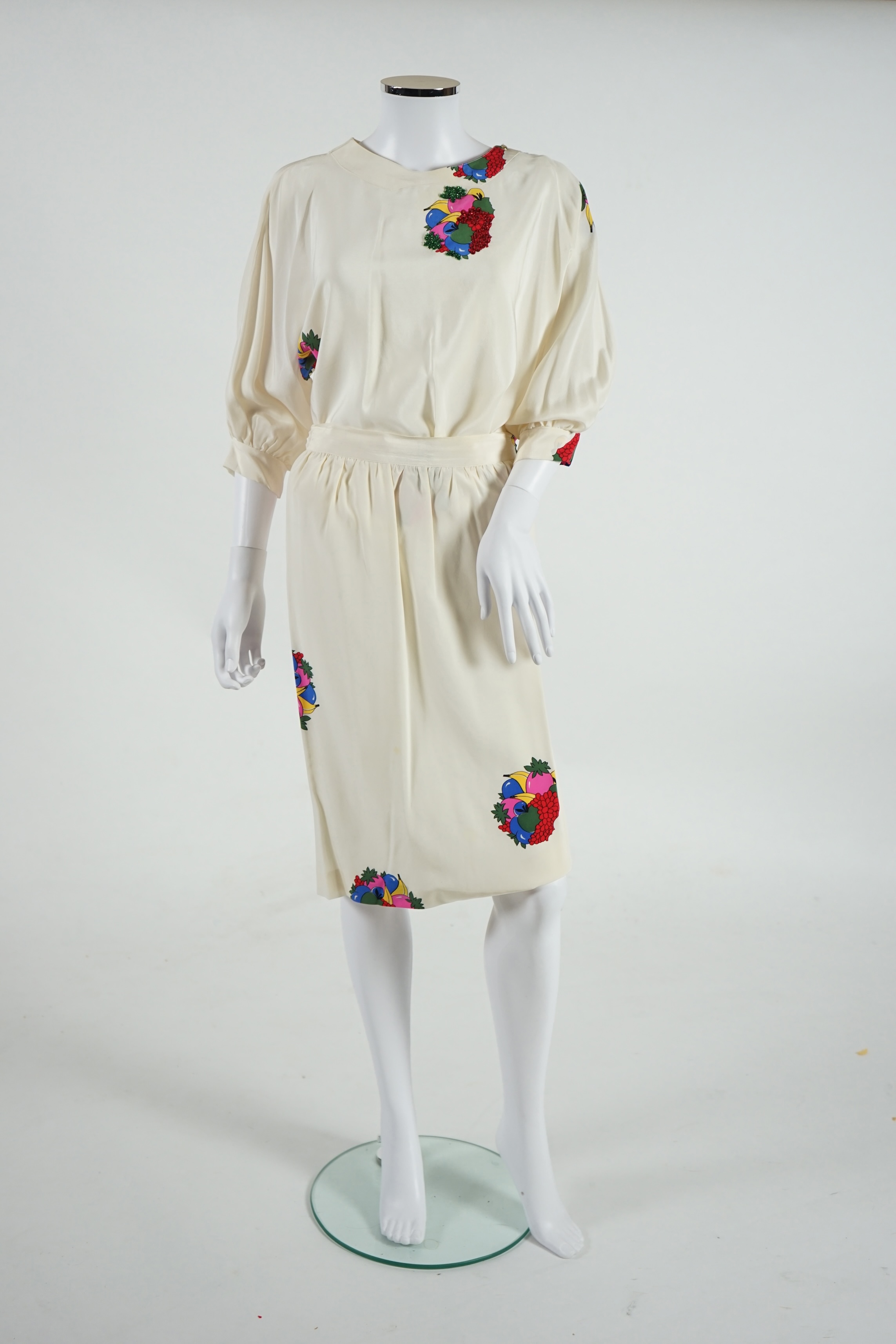 A lady's Angela Caputi silk cream skirt and blouse with fruit design size 46, a Ted Baker white lightweight cardigan with leaf design to the back size 4, a Rawhide dusky pink long laser cut coat size 14 and a Georgina vo